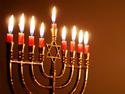 A menorah with all of the candles lit