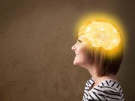 photo of happy woman with glowing yellow brain