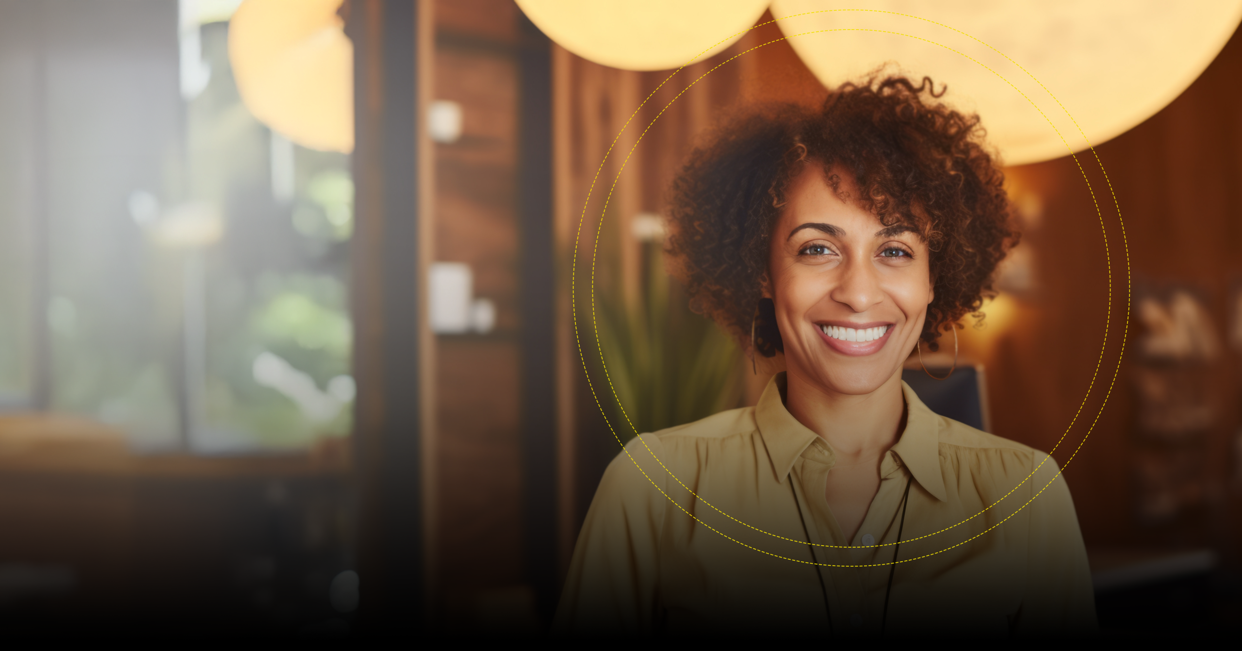 A smiling, confident woman sits in a modern, well-lit office, representing the positive culture driven by The Happiness Index.